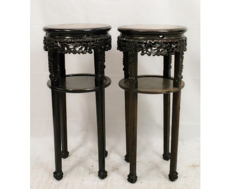 Pair of Chinese hardwood jardiniere plant stands, late Qing period, the round inset variegated marble tops over fretwork apro