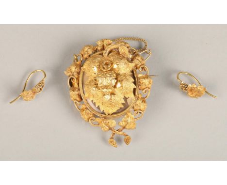 Victorian yellow metal leaf form locket pendant brooch and matching earrings (test as gold), the locket profusely decorated w