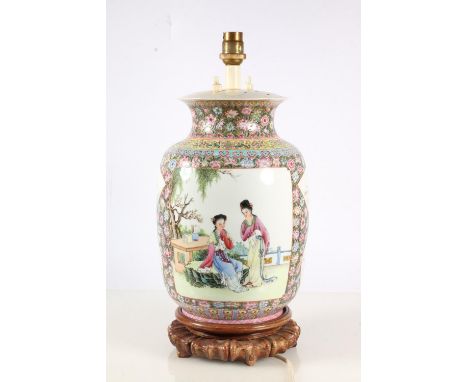 Chinese porcelain Famille Rose table lamp, mid 20th century, of baluster shape, the reserve panels finely painted with attend