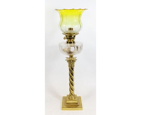 Victorian brass oil lamp, of wrythen Corinthian column form on stepped base, clear slice cut reservoir below burner with etch