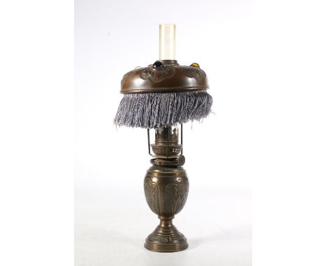 French Art Nouveau table oil lamp, c1900, the copper anodized shade embossed with a lily of the valley pattern, set with thre