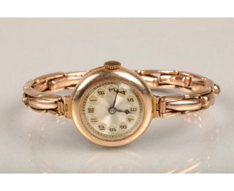 9ct gold cased ladies cocktail wristwatch, the round 9ct gold cased watch on 9ct gold extender bracelet. Good condition with 