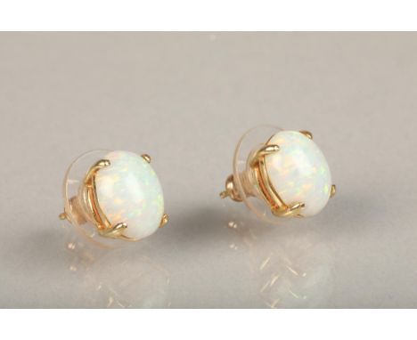Pair of oval white opal cabochon earrings, basket mounted on yellow metal mounts, opal size each approx. 2ct, no hallmarks pr