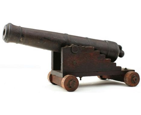 A 19TH CENTURY CAST IRON MODEL NAVAL CANNON, 15.75inch five-stage barrel with flared ring turned muzzle, plain trunnions and 