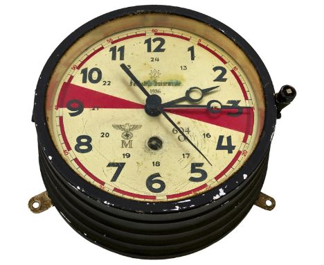 A THIRD REICH NAVAL CLOCK, the stepped black painted body with glazed door, silvered dial with red sector markings, Kriegsmar