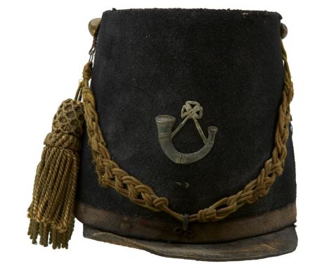 A CONTINENTAL STYLE THEATRICAL SHAKO. Stiffened blue cloth, unbound soft leather peak, sewn-in cap lines and tassels, small b