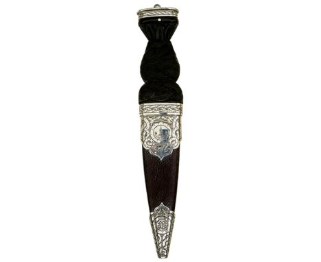 A SILVER MOUNTED SCOTTISH SGIAN DUBH, 8.25cm blade with faceted back edge, characteristic silver mounted hilt, the pommel eng