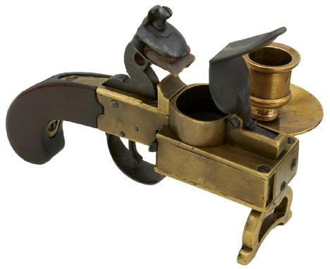 A LARGE COMBINATION FLINTLOCK TINDER LIGHTER AND CANDLE HOLDER, the plain brass action with sprung compartment, pierced stand