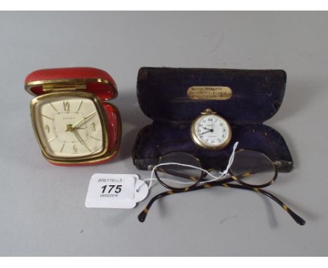 A Set of Tortoise Shell Framed Spectacles Alarm Clock and Watch.