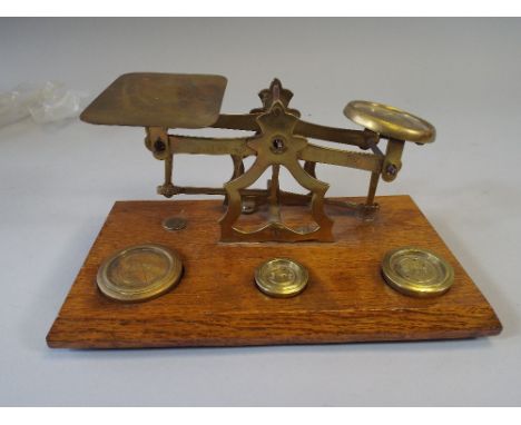 A Set of Brass Postage Scales on Wooden Plinth with Inset Weights.