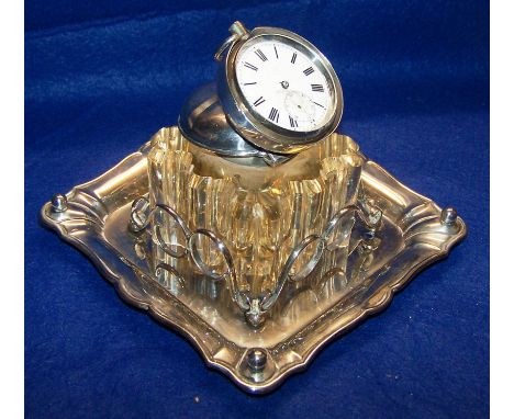 An Edwardian square silver Inkstand inset with a glass block inkwell, the cover inset with a pocket watch, London, 1900, make