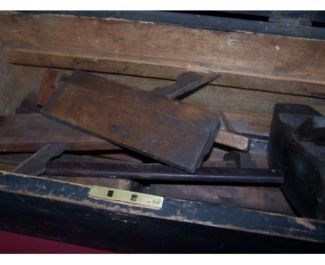 A collection of old wooden Moulding Planes and a pine tool box.