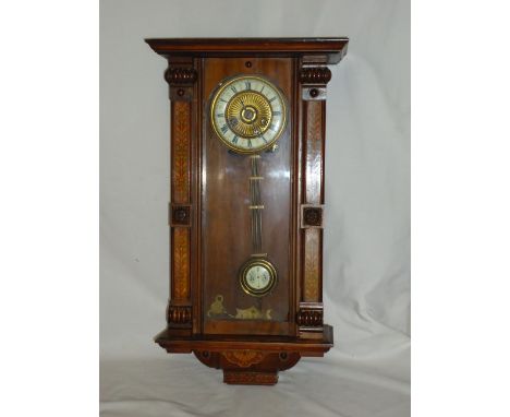 A late 19th Century Vienna type Wall Clock with ivorine dial, the walnut case inlaid with panels of floral marquetry.  25" (6