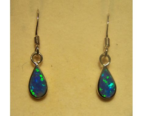 A pair of silver Pendant Earrings, each set with a blue opal.