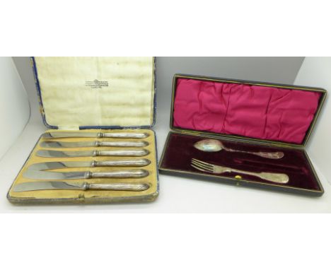 A cased set of six silver handled butter knives and a plated spoon and fork