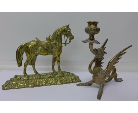 A brass horse door stop and a brass dragon candlestick