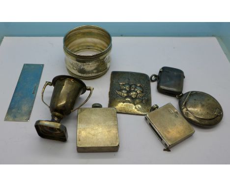 Assorted silver including a vesta case and a trophy, a white metal napkin ring and one plated item, (six hallmarked items)