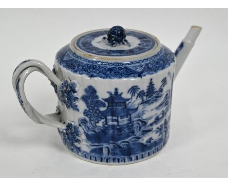 An 18th century Chinese blue and white teapot and cover with moulded pomegranate finial and foliate mounted double strap hand