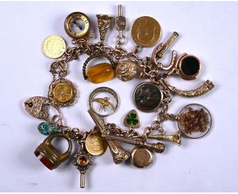 A 9ct rose gold curb bracelet c/w padlock and safety chain, with 24 various charms attached including coins, compass, watch k