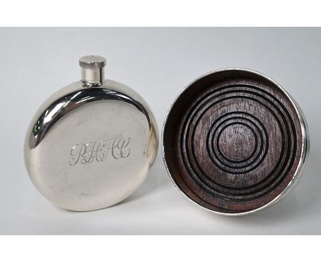 A silver hip flask of disc-form, Birmingham 1990, 3.5oz (110g), 9cm diameter, to/w a bottle coaster with turned wood base, Bi