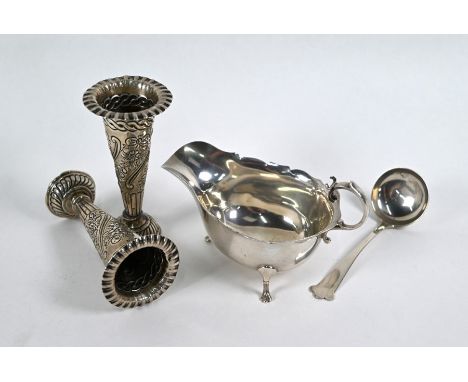 A silver sauce-boat with cut rim and scroll handle, on paw feet, with sauce ladle with trifid finial, both Horace Woodward &a