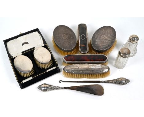 A pair of gentleman's oval hairbrushes with engine-turned silver backs, London 1945 and a pair of children's silver-backed ha