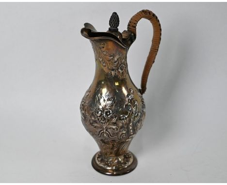 A late Victorian small ewer of baluster form, with floral and foliate embossed decoration, hinged cover and wicker-bound scro