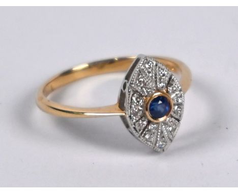 A diamond and sapphire elliptical cluster ring, the central blue sapphire surrounded by radiating diamonds, milgrain set, 9ct