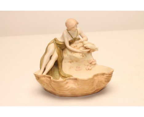 AN ART NOUVEAU ROYAL DUX BISQUE PORCELAIN FIGURAL SMALL CENTREPIECE modelled as a young scantily draped maiden reclining on a