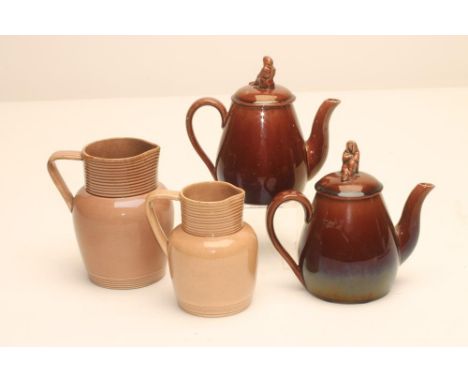 TWO GRADUATED ROCKINGHAM EARTHENWARE JUGS, c.1830, of rounded cylindrical form with engine turned neck and angular handle in 