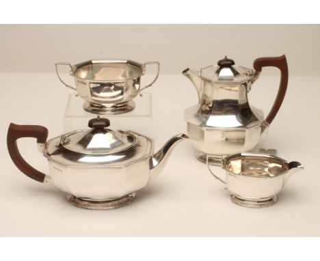 A THREE PIECE SILVER TEA SERVICE, makers Adie Bros., Birmingham 1933, of octagonal form with cast straight gadrooned everted 