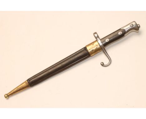 A RARE ITALIAN BAYONET, c.1871, with 11" tapering cruciform blade, hooked quillon, two piece wood grip and leather scabbard w