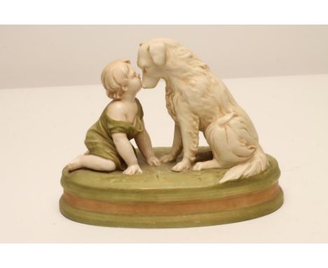 A ROYAL DUX BISQUE PORCELAIN FIGURE, early 20th century, modelled as a toddler beside a retriever, on a green oval base, pink