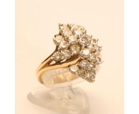 A DIAMOND ABSTRACT CLUSTER RING, the twenty seven brilliant cut stones totalling approximately 2.50cts to open forked shoulde