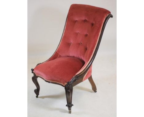 A VICTORIAN ROSEWOOD FRAMED NURSING CHAIR of Grecian design, button upholstered in pink dralon, leaf carved scrolled back upr