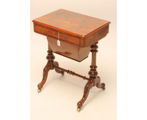 A VICTORIAN WALNUT PILLAR END WORK TABLE of rounded oblong form, moulded edged burr top with central panel and stringing, fri