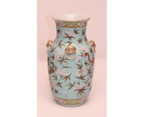 A CHINESE PORCELAIN VASE of rounded cylindrical form, the sloping shoulders applied with four dog of fo mask fixed ring handl