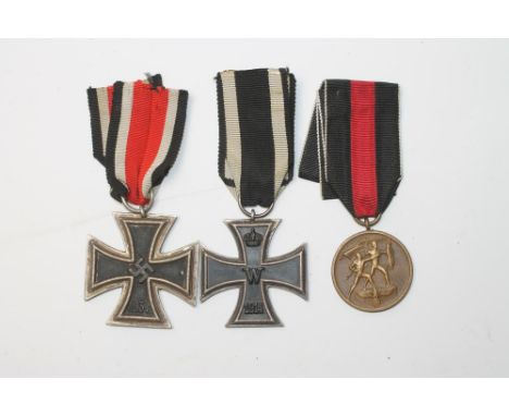 A GERMAN IRON CROSS dated 1914, with suspension ring and ribbon, another dated 1939 with suspension ring and ribbon, together