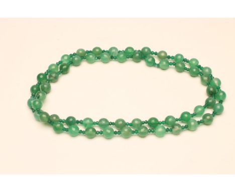 A SINGLE STRING OF AUSTRALIAN JADE BEADS, the fifty six faceted beads with double emerald facet cut bead spacers    (Est. plu