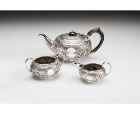 A BACHELOR'S LATE VICTORIAN THREE PIECE SILVER TEA SERVICE, makers Aldwinkle & Slater, London 1886, of squat globular form, h