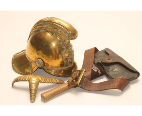 A BRASS FIREMAN'S HELMET, late19th/early 20th century, with crossed axe emblem, dragon crest and rose bosses, together with a