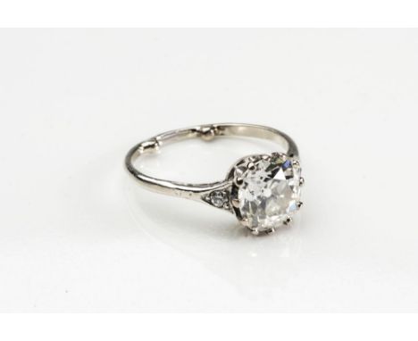 A SOLITAIRE DIAMOND RING, the brilliant cut cushion stone of approximately 2.5cts, claw set to triangular shoulders each poin