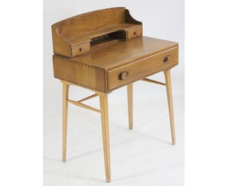 AN ERCOL ELM DESK, the mildly arched raised back with downswept sides enclosing a shelf over two small drawers, frieze drawer