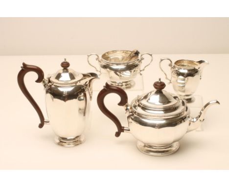 A FOUR PIECE SILVER TEA AND COFFEE SERVICE, makers Adie Bros., Birmingham 1929, of panelled cylindrical form, comprising tea 