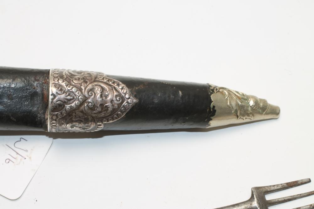 A SCOTTISH DIRK, 19th century, the fullered blade with serrated back