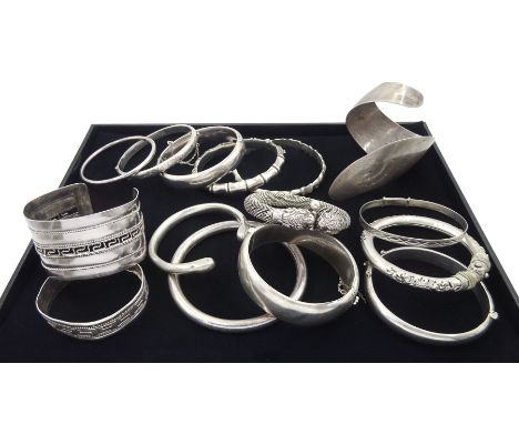 Collection of twelve silver bangles and two white metal banglesCondition Report:Silver approx 270gm, one bangle 50% silver ap