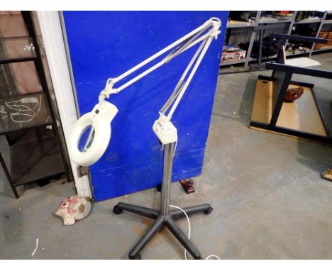 Magnifying lens on a wheeled base. All electrical items in this lot have been PAT tested for safety and have passed. This doe