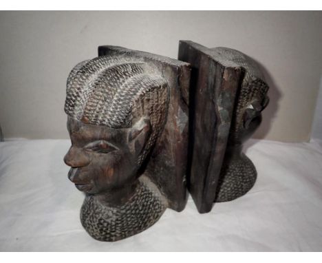 Pair of African carved bookends. P&amp;P Group 2 (£18+VAT for the first lot and £3+VAT for subsequent lots) 
