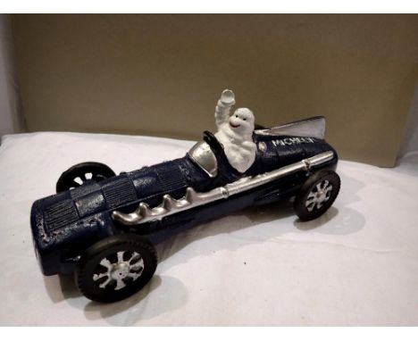 Cast iron Michelin Man racing car, L: 26 cm. P&amp;P Group 1 (£14+VAT for the first lot and £1+VAT for subsequent lots) 