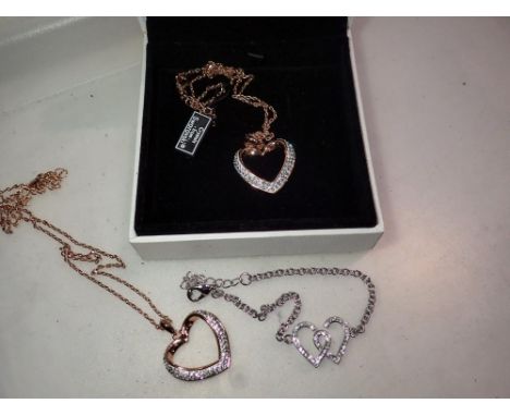 Two boxed Warren James Swarovski crystal heart pendant necklaces, largest chain L: 40 cm and a bracelet (3). P&amp;P Group 1 